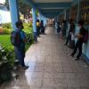 Basico (Middle School) students come to the school each Monday to turn in work from the previous week and pick up work for the coming week.  Here, 7th graders, socially distanced wait in line for their turn to turn in their work.